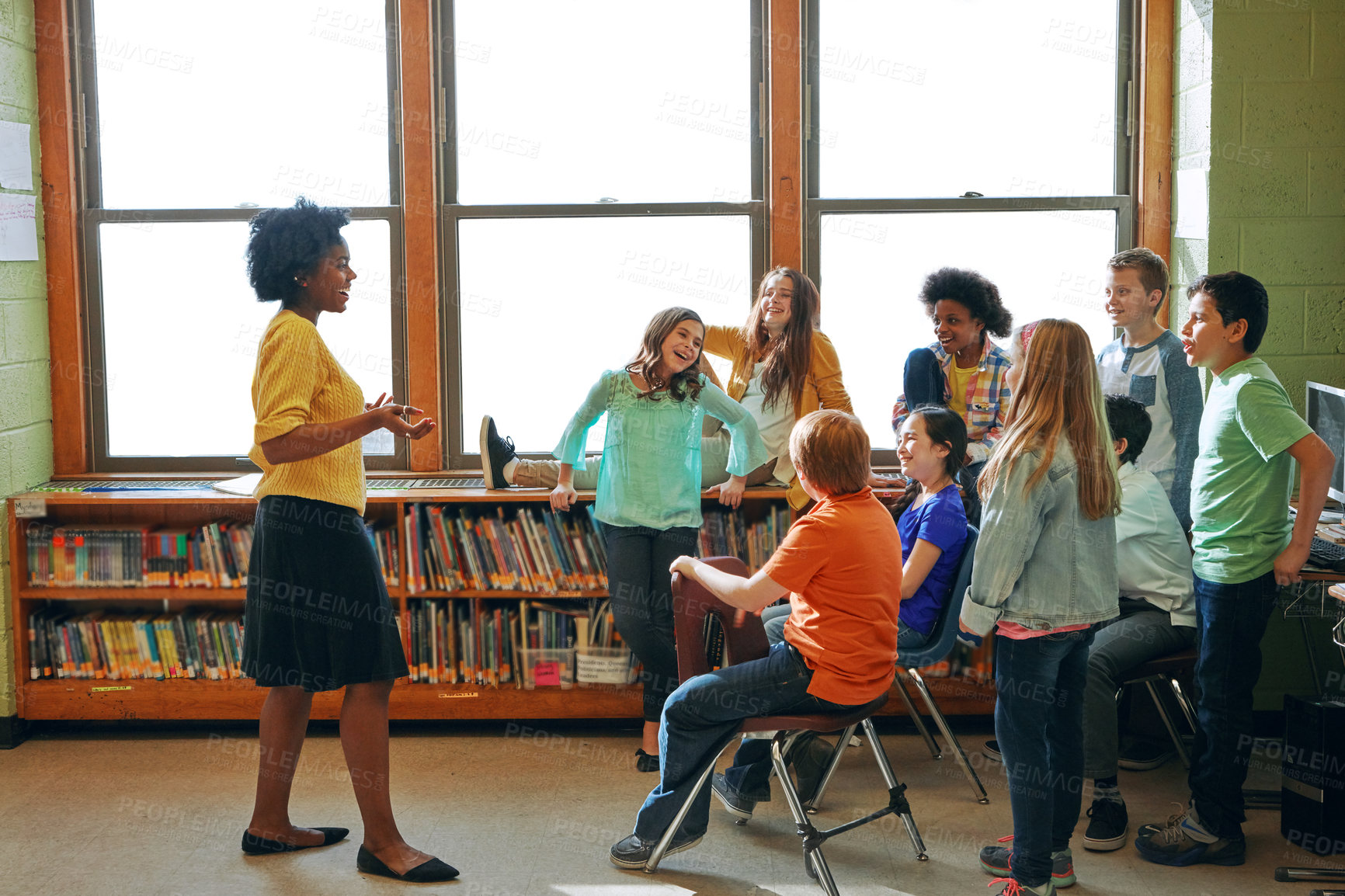 Buy stock photo Shot of a young teacher educating a group of elementary children