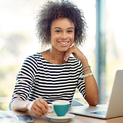 Buy stock photo Portrait of a young woman drinking a coffee while working on a laptop at home