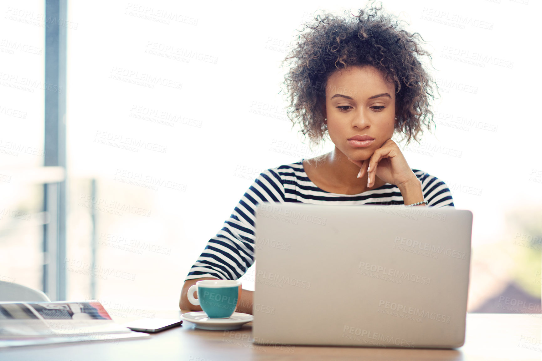 Buy stock photo Shot of a young woman working on a laptop at home