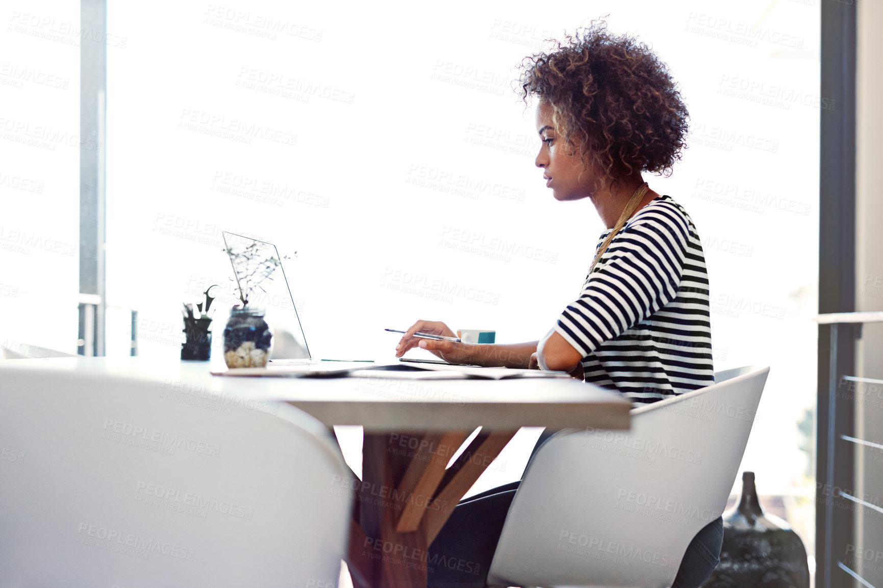 Buy stock photo Design, laptop and remote work with business woman at desk in office for report or research. Computer, concentration and typing with profile of serious employee in apartment for online administration