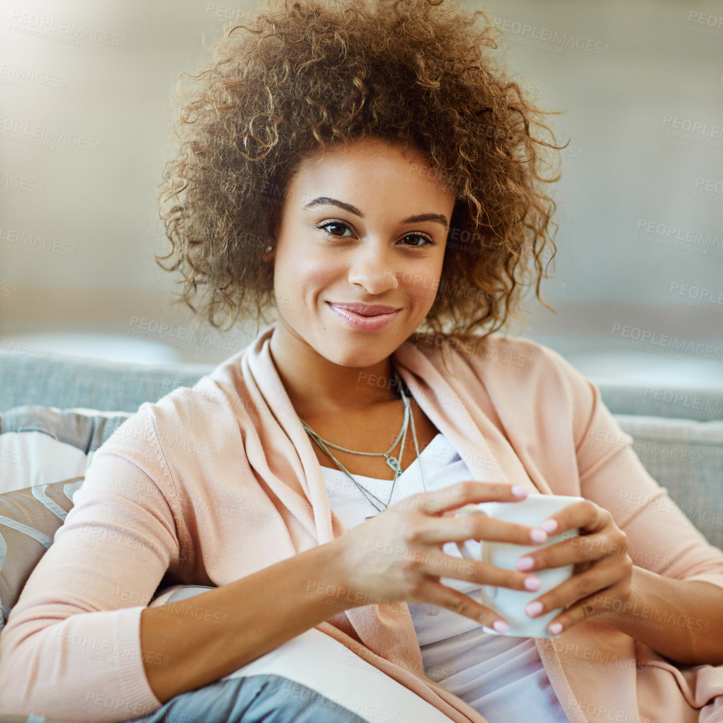 Buy stock photo Portrait of a young woman relaxing with a warm beverage at home