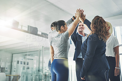 Buy stock photo Shot of a diverse group of coworkers high fiving together in an office