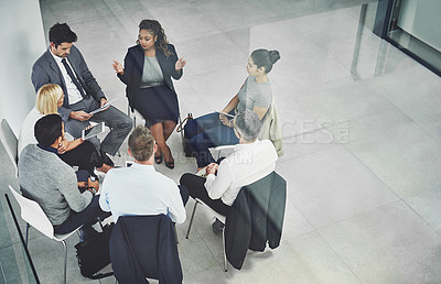 Buy stock photo High angle shot of a group of coworkers talking together while sitting in a circle in an office