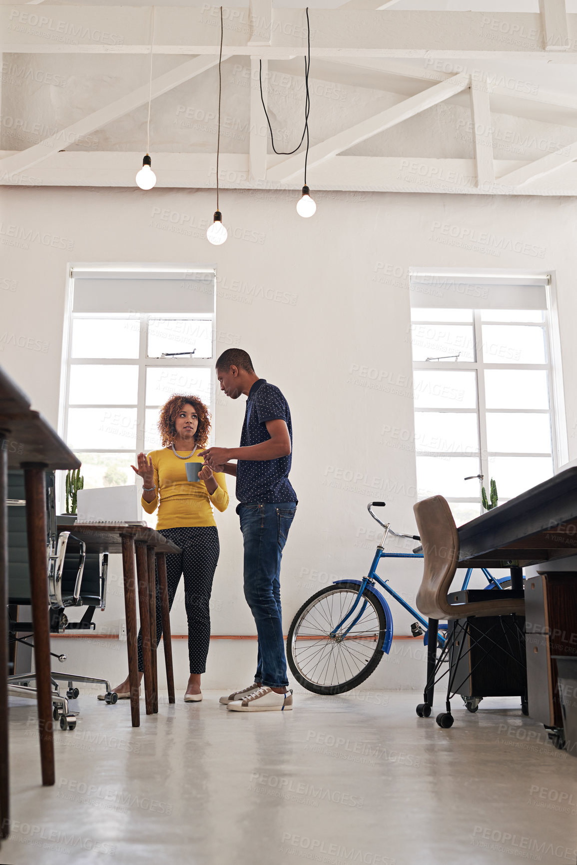 Buy stock photo Shot of coworkers having an informal meeting with a laptop in a modern office