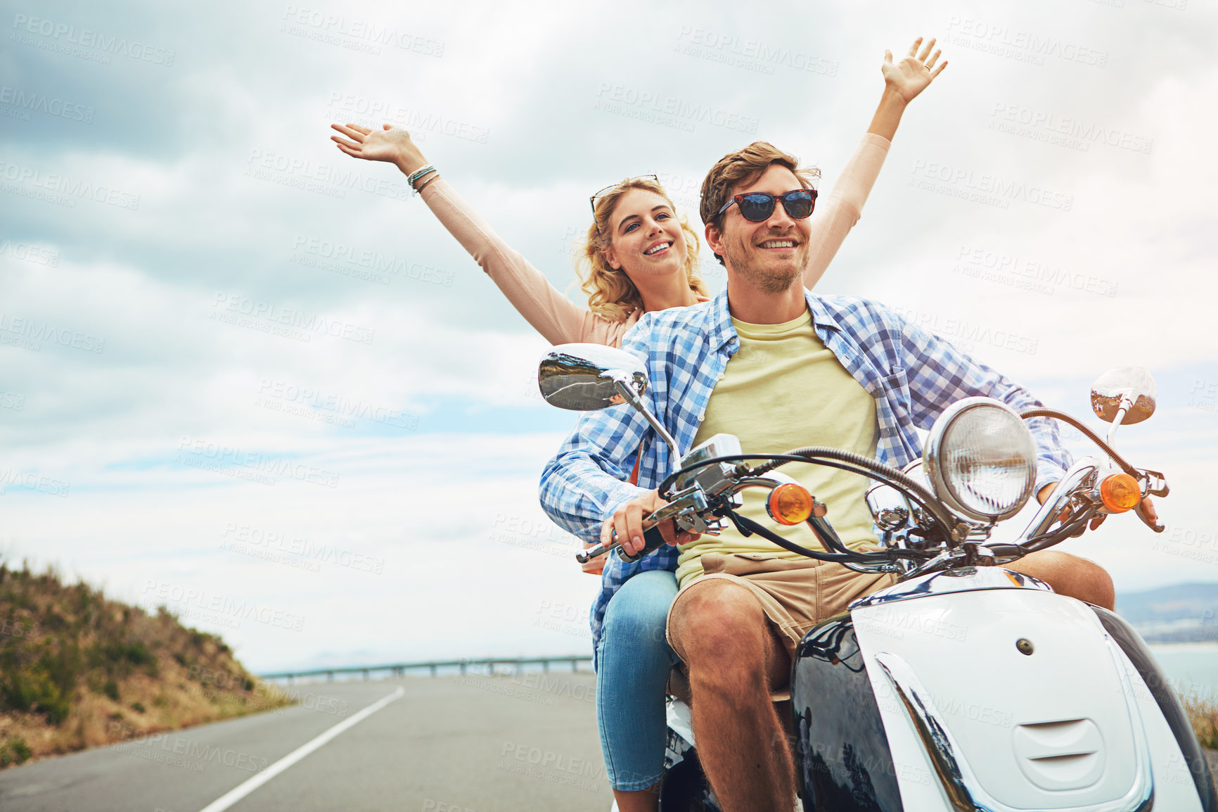 Buy stock photo Shot of a young couple out for a ride on a scooter