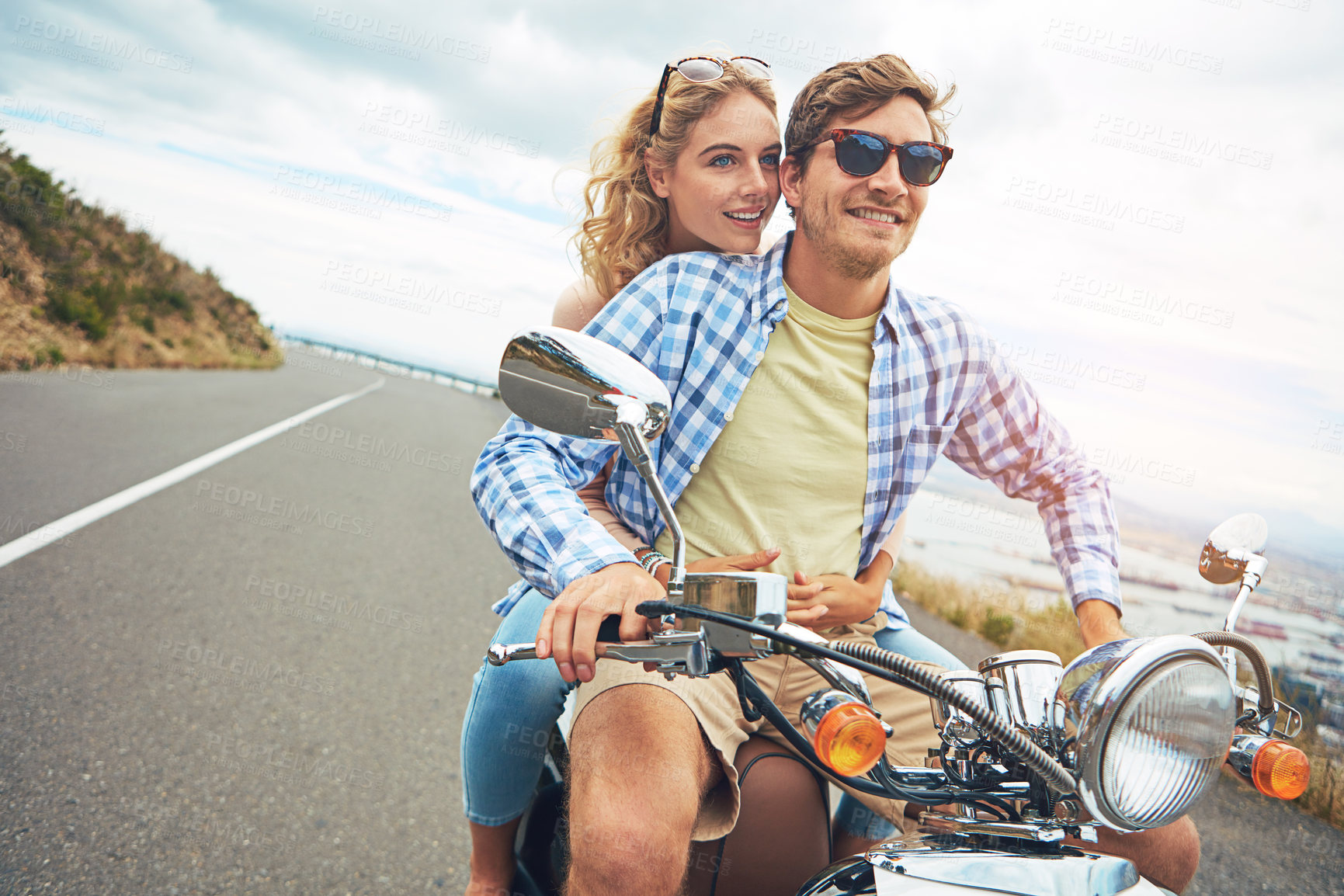 Buy stock photo Shot of a young couple out for a ride on a scooter