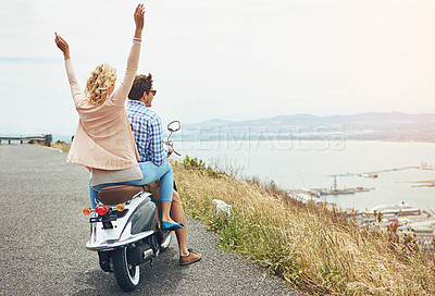 Buy stock photo Shot of a young couple out for a ride on a scooter