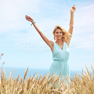 Buy stock photo Shot of a young woman in a field on a sunny day