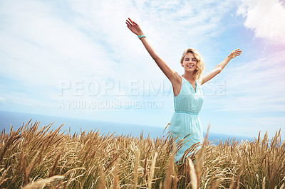 Buy stock photo Shot of a young woman in a field on a sunny day