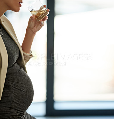 Buy stock photo Shot of a woman drinking whiskey while preganant