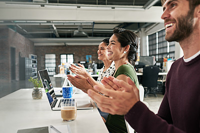Buy stock photo Shot of a team of colleagues clapping during a meeting in a modern office