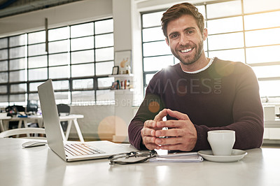 Buy stock photo Portrait of a young businessman working at his desk in a modern office