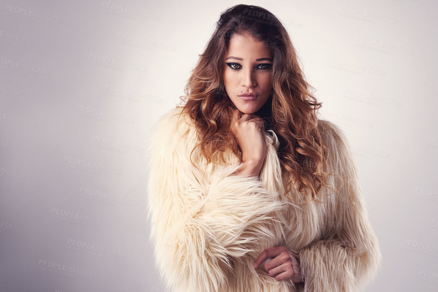 Buy stock photo Studio portrait of a young woman posing against a grey background