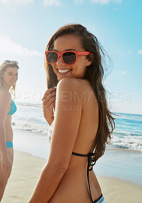 Buy stock photo Portrait of two friends hanging out at the beach