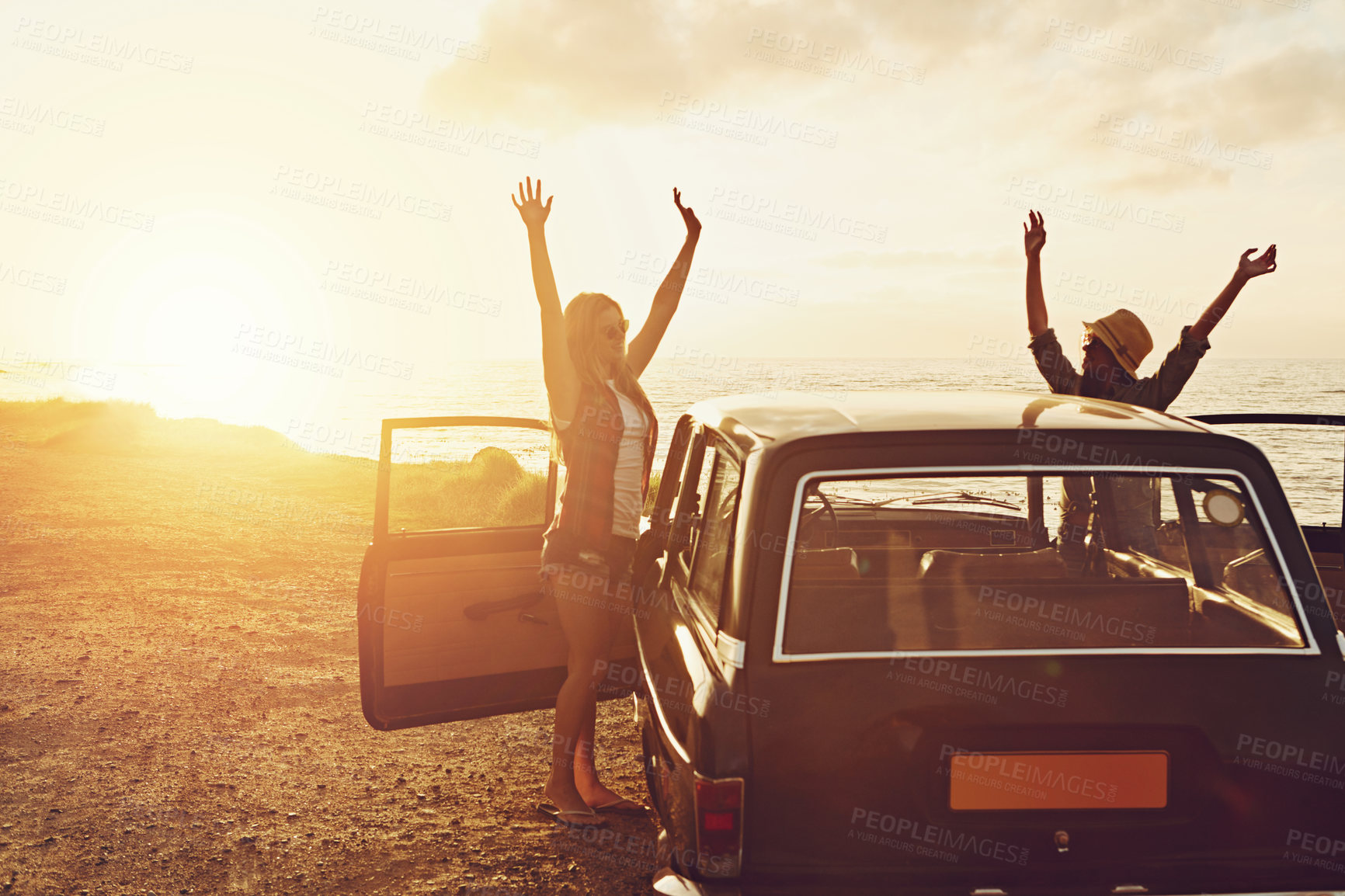 Buy stock photo Sunset, road trip and couple of friends at beach for travel, journey and holiday, freedom and celebration. Celebrate summer and happy vintage or retro women with car for vacation and parking by ocean