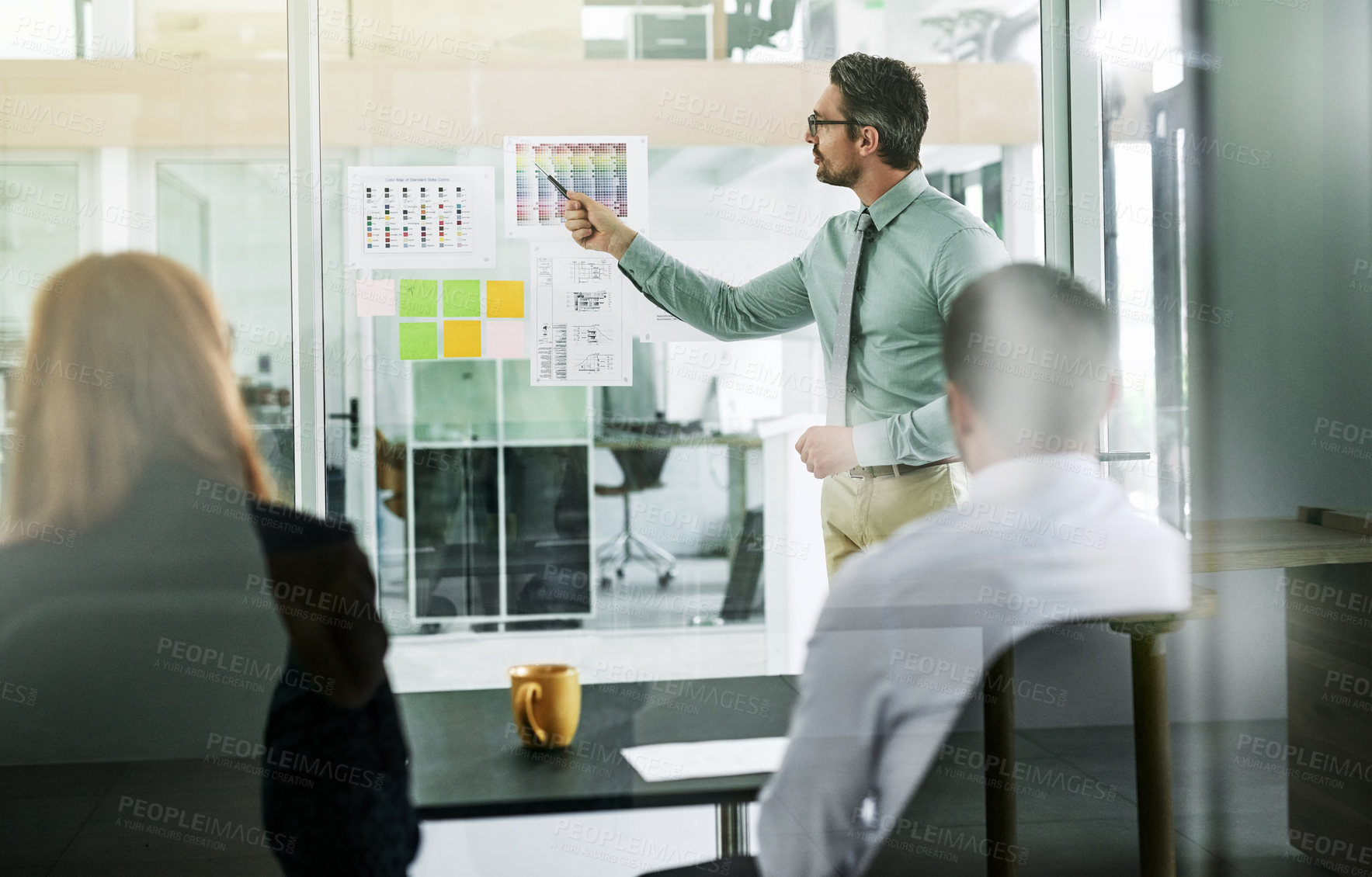 Buy stock photo Shot of a businessman giving a presentation to his colleagues in an office