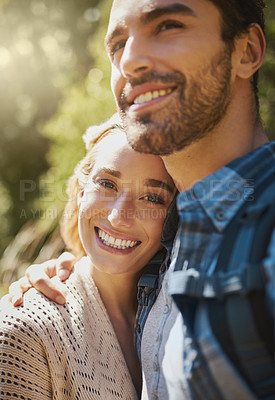 Buy stock photo Shot of a happy young couple spending time together in nature