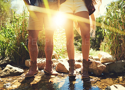 Buy stock photo Cropped shot of a couple standing together in a rocky stream