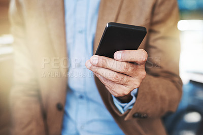 Buy stock photo Cropped shot of a businessman using a mobile phone