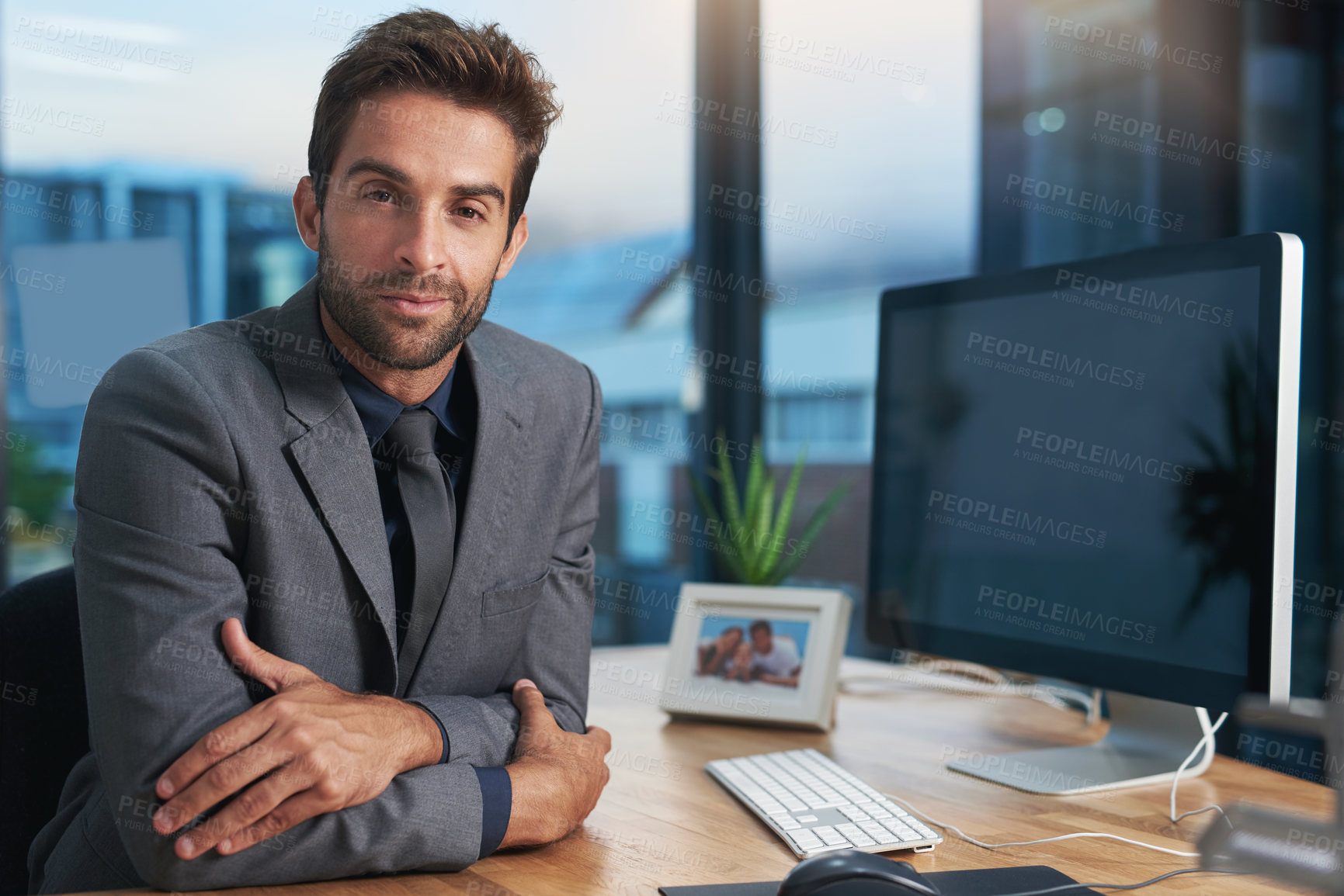 Buy stock photo Portrait of a young businessman sitting at his desk