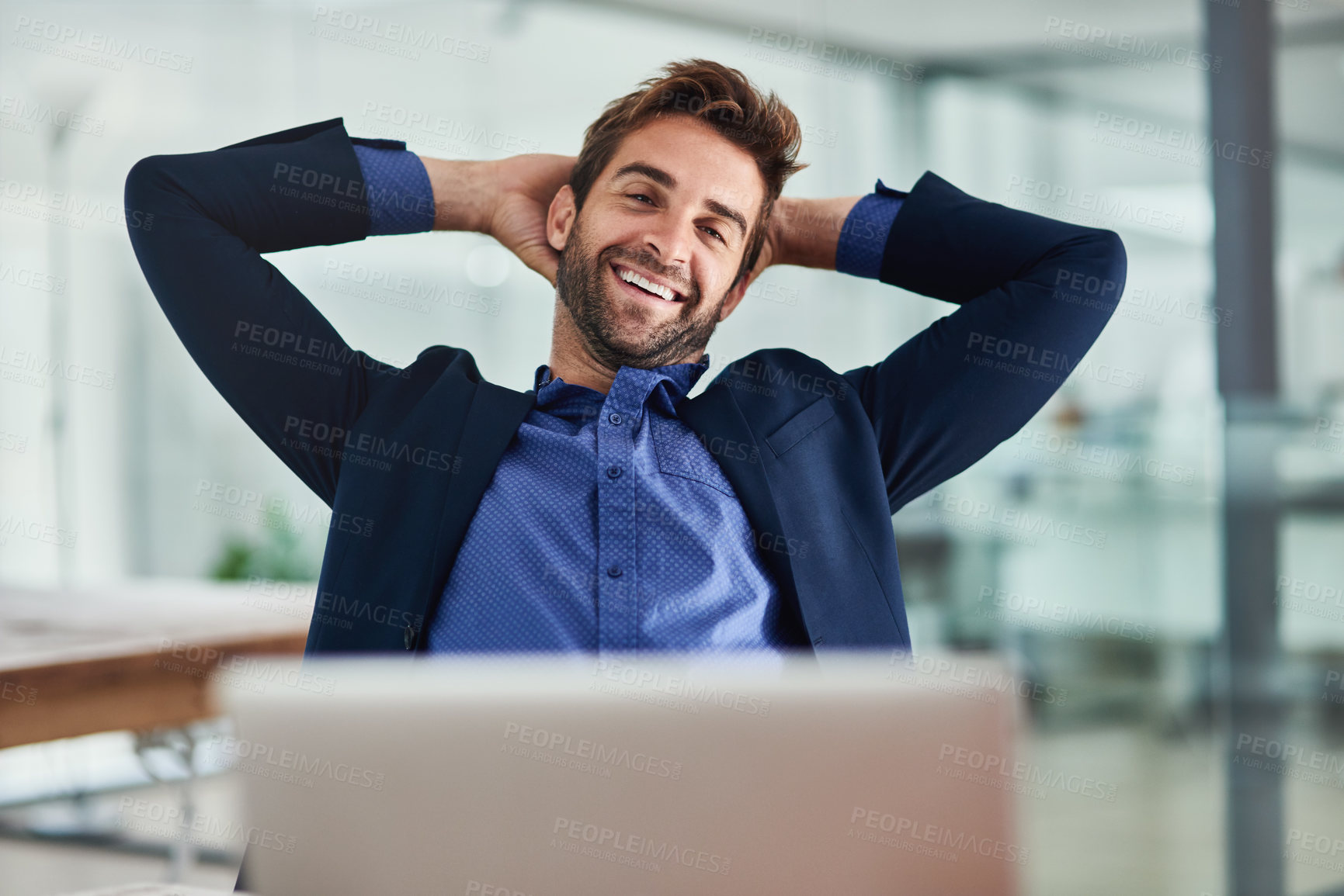 Buy stock photo Portrait of a young businessman taking a break at an office desk