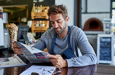 Buy stock photo Small business, cafe and man at table with newspaper, paperwork and relax in coffee shop. Reading, working and restaurant manager, waiter or owner checking news for service industry startup economy