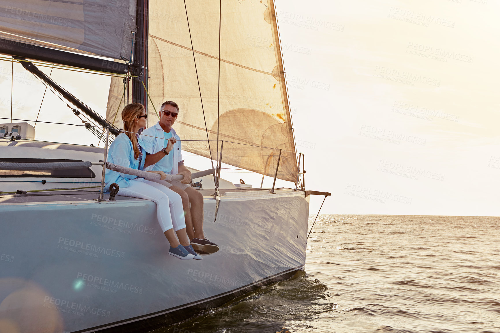 Buy stock photo Relax, travel and luxury with couple on yacht for summer, love and sunset on Rome vacation trip. Adventure, journey and vip with man and woman sailing on boat for ocean, tropical and honeymoon at sea