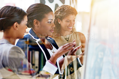 Buy stock photo Shot of a group of female coworkers brainstorming together in an office