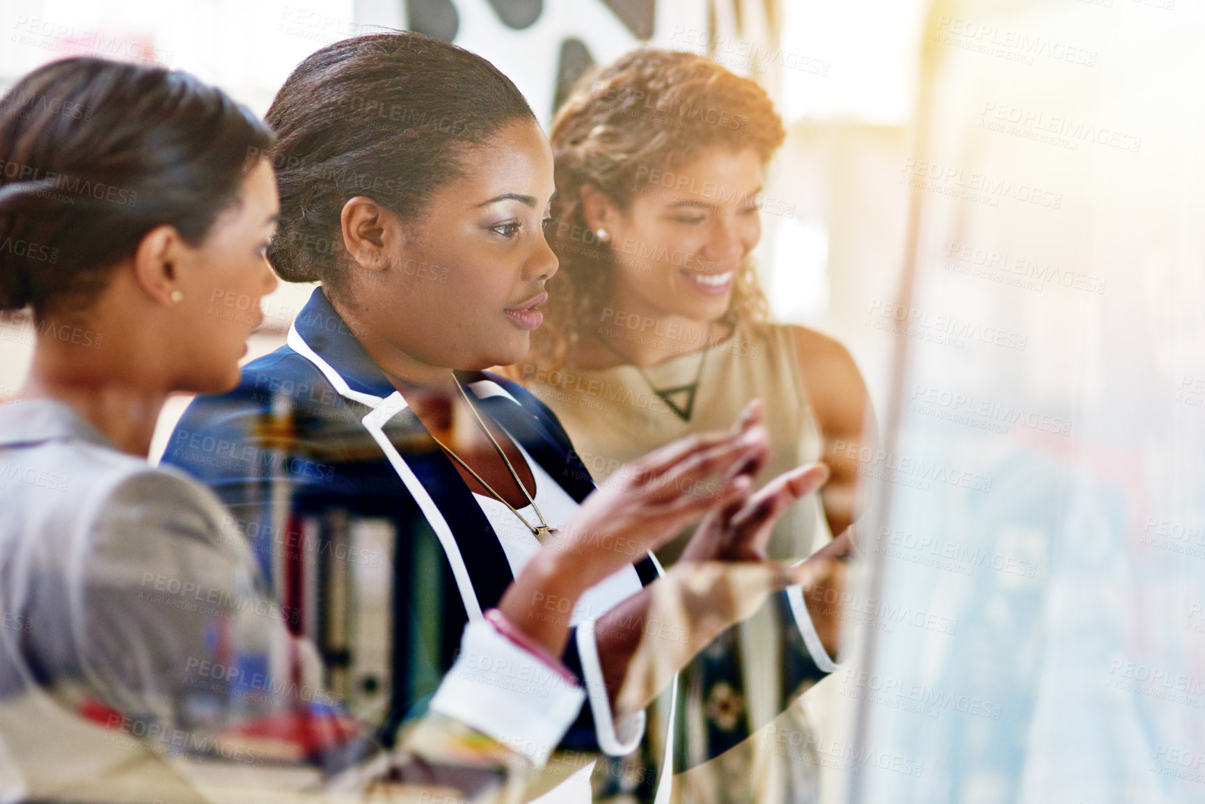 Buy stock photo Shot of a group of female coworkers brainstorming together in an office