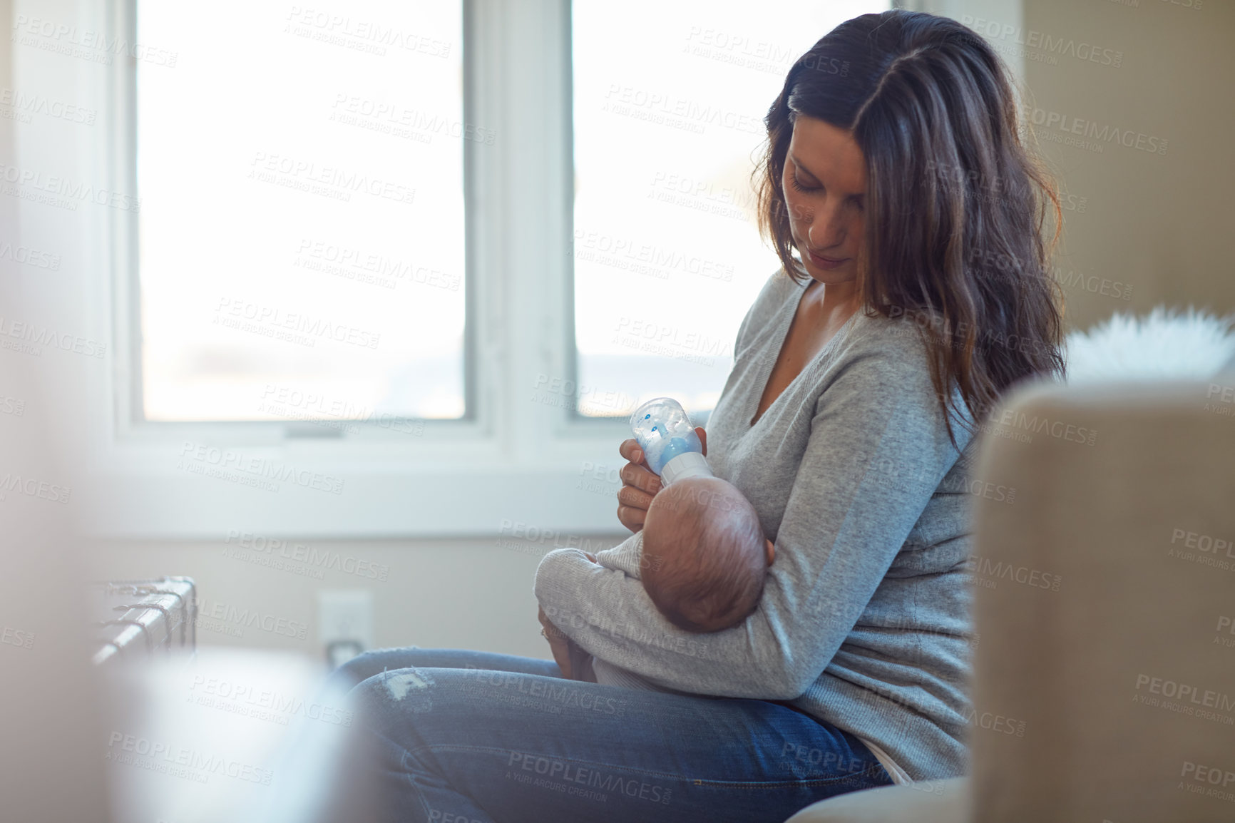 Buy stock photo Mom, feeding and baby with bottle in home for childhood development, growth or nutrition. Mother, newborn or infant drinking with milk for vitamins, immune booster or health and wellness in house