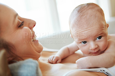 Buy stock photo Closeup shot of a mother lying down with her newborn baby on top of her