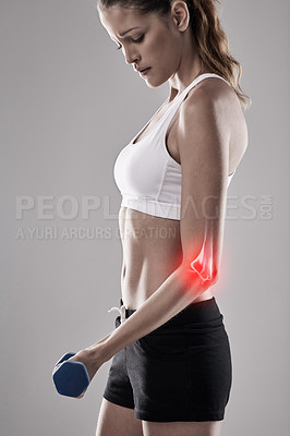 Buy stock photo Sports injury, woman and elbow with red glow for fitness, workout and gym in studio. Lateral Epicondylitis, pain and athlete with weight for training, exercise and motivation on gray background