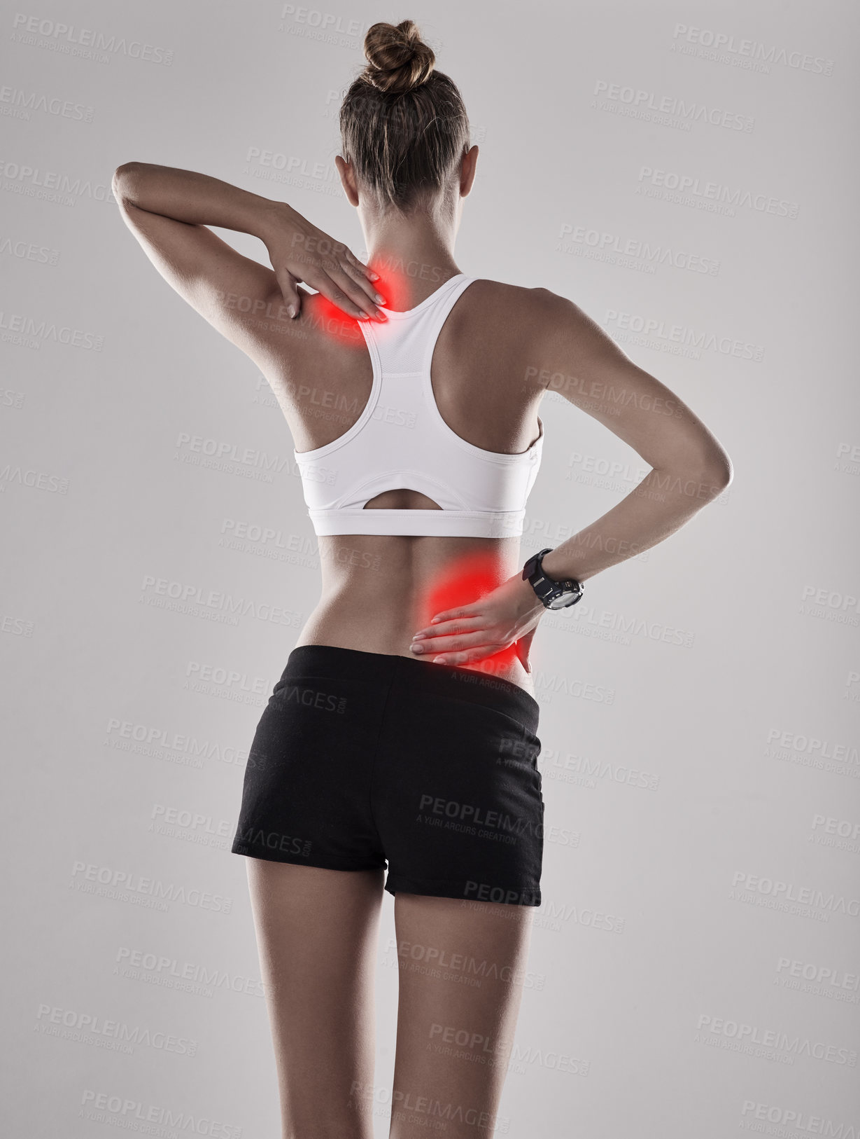 Buy stock photo Shot of a young woman holding her injured back and shoulder that's highlighted in red