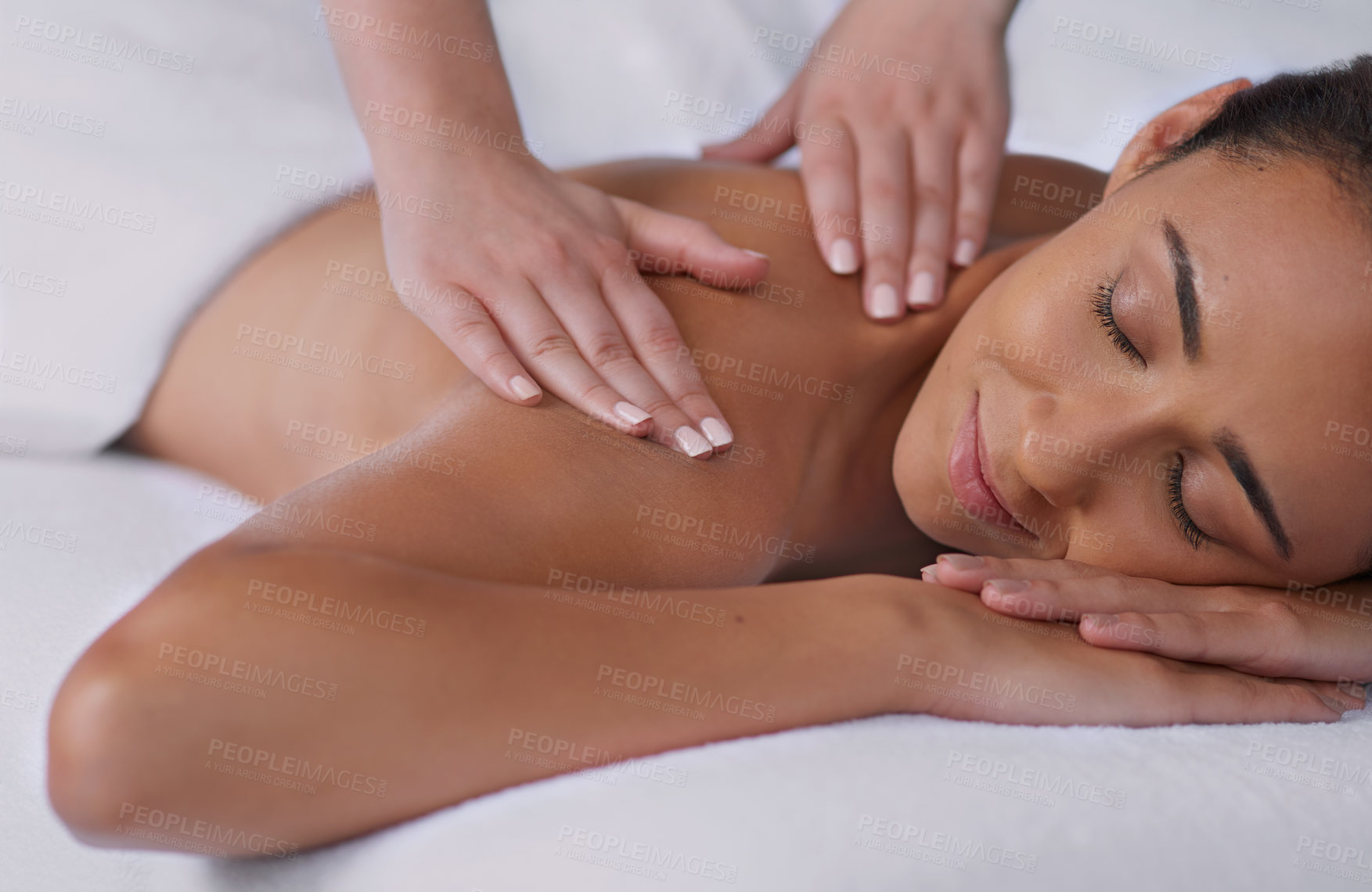 Buy stock photo Shot of a beautiful young woman enjoying a back massage at a spa