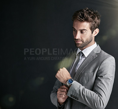 Buy stock photo Studio shot of a confident young businessman against a black background