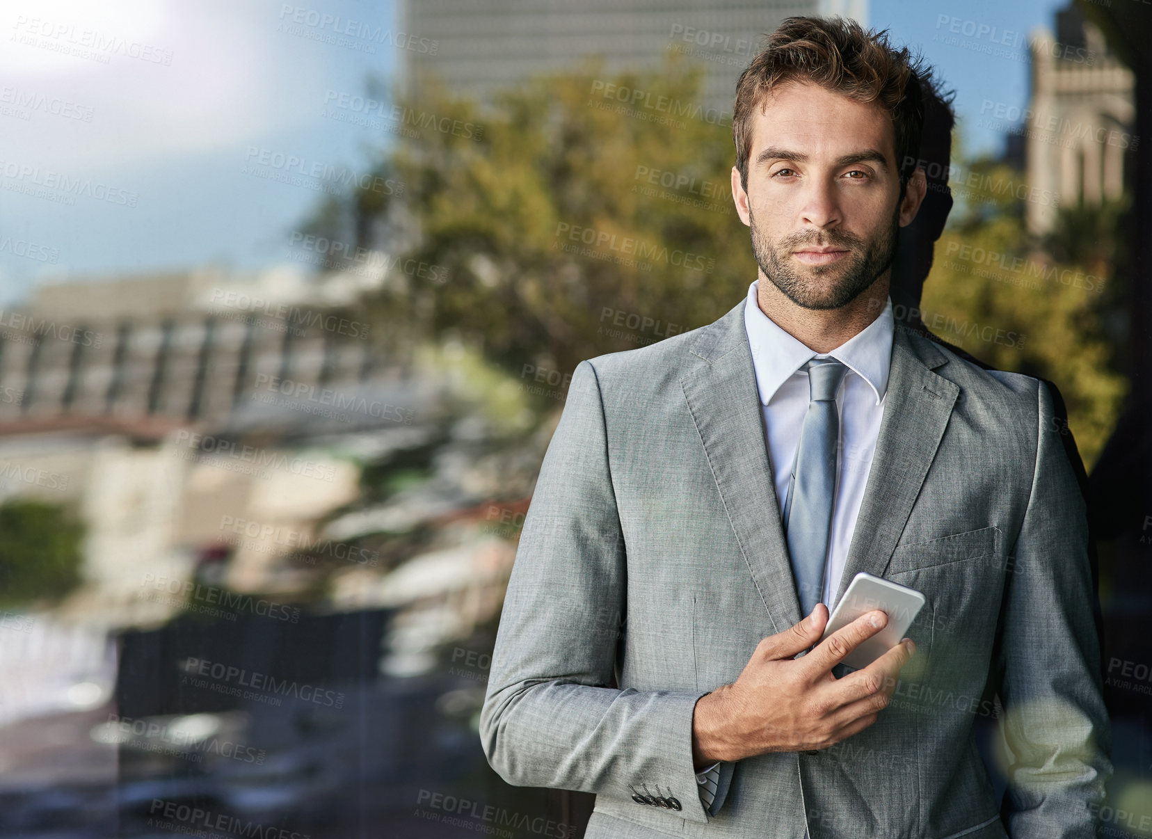 Buy stock photo Portrait, businessman and confident on glass window as property agent with social media, tech and suit in outdoor. Male person, pride and real estate for work, corporate or career in New York City