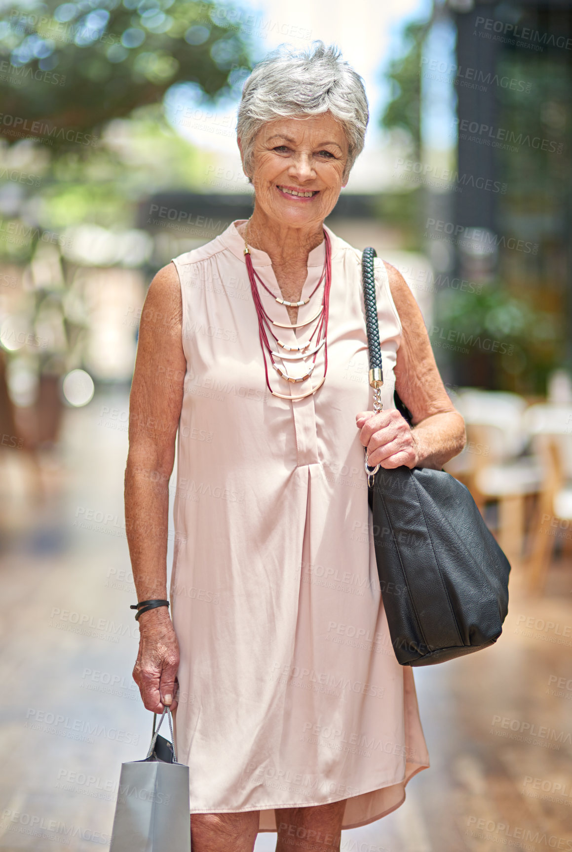 Buy stock photo Portrait, shopping or elderly woman in mall for retail outlet with smile, fashion choice or retirement. Confidence, customer or happy senior lady in store for clothes sale, discount deal or bargain