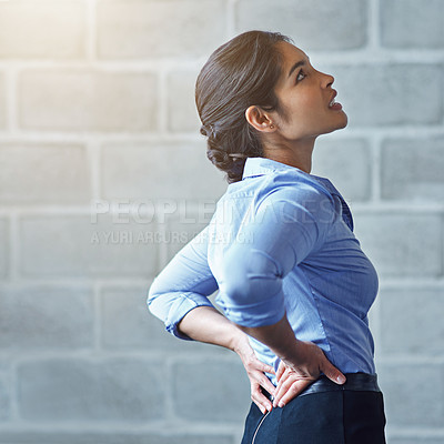 Buy stock photo Back pain, office stress and business woman with muscle injury, health risk and fatigue on mockup wall. Uncomfortable female worker, spine problem and bad posture of injured body, scoliosis and joint