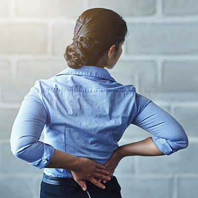 Buy stock photo Rearview shot of a businesswoman suffering from back pain