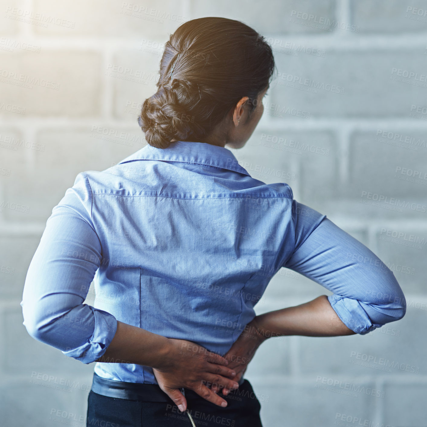 Buy stock photo Rearview shot of a businesswoman suffering from back pain