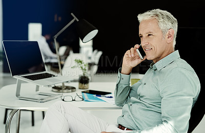 Buy stock photo Shot of a mature businessman working at his desk in an office