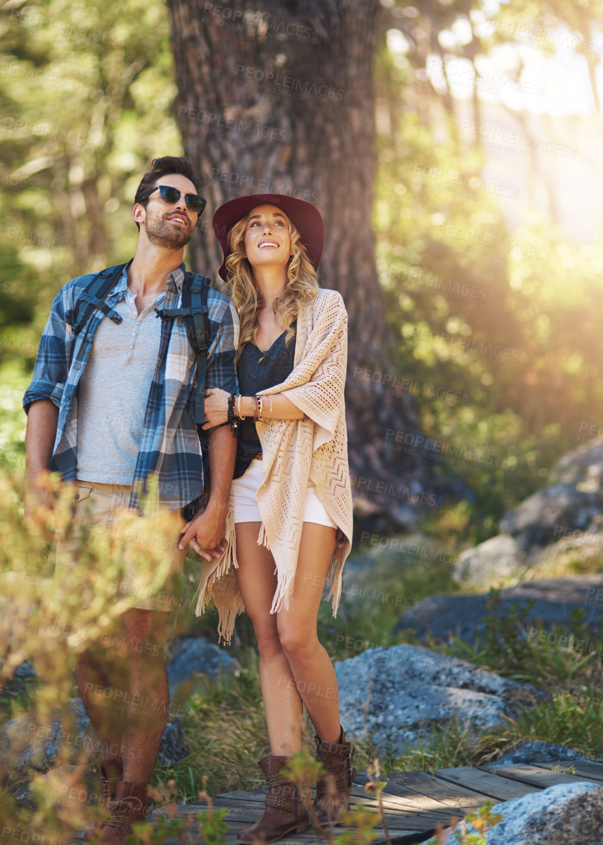 Buy stock photo Looking, couple and happy outdoor for hiking in nature on vacation, together and walking in forest for adventure. Man, woman and smile in woods for explore on travel holiday in New Zealand with love.