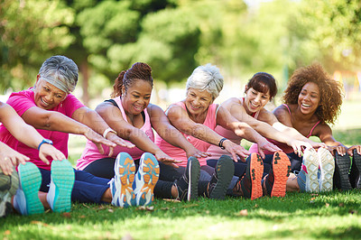 Buy stock photo Shot of a group of people warming up outdoors