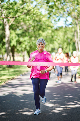 Buy stock photo Shot of a senior woman about to win a marathon