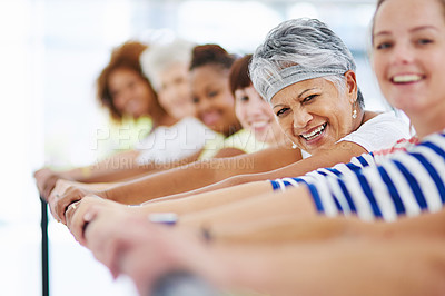 Buy stock photo Shot of a group of women working out indoors