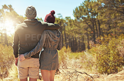 Buy stock photo Rearview shot of an affectionate young couple hiking