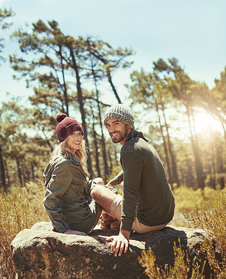 Buy stock photo Rearview shot of an affectionate young couple taking a break while hiking