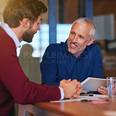 Buy stock photo Shot of two businessmen having a meeting in an office