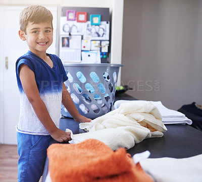 Buy stock photo Child, portrait and clothing laundry in home for cleaning chores, responsibility or independent. Boy, face and smile in bedroom for housekeeping to do list for routine task as folding, proud or tidy