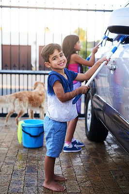 Buy stock photo Children, fun and home and washing car, portrait kids cleaning motor vehicle with equipment. Siblings, driveway and helping with responsibility together on weekend, happy in outdoor for chore